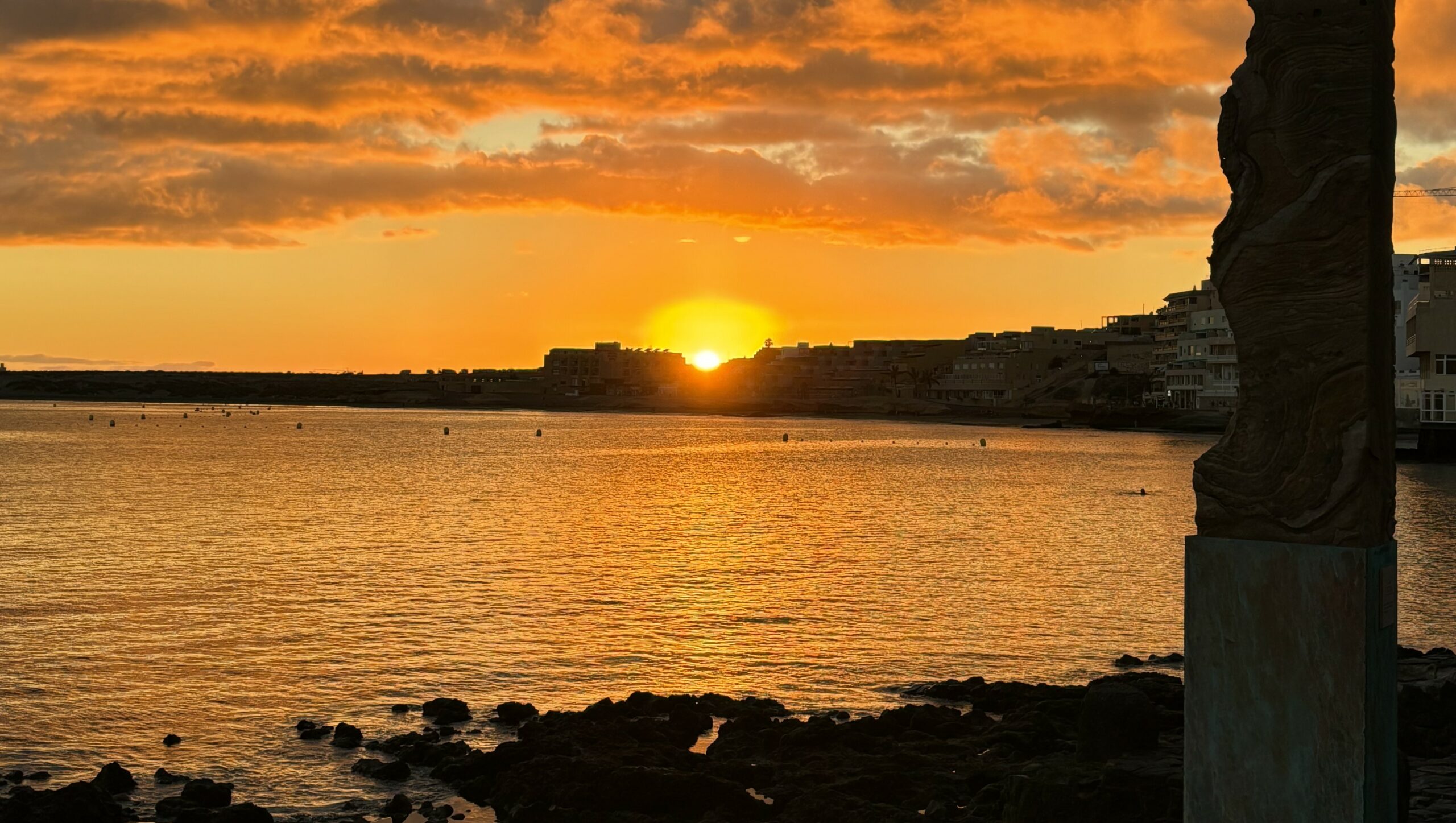 Sun setting over an ocean port